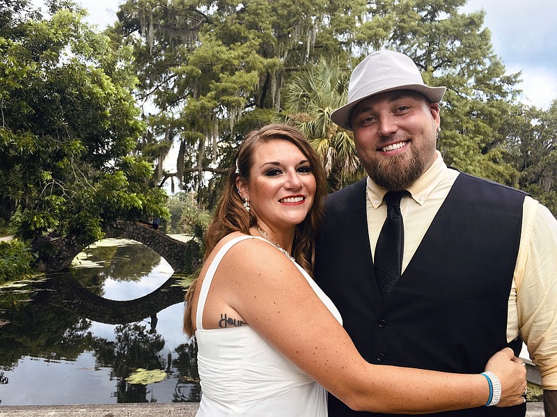 This image released bu Jordan Tyler shows Tyler, right, with his wife Brittany in New Orleans on July 18, 2020. The couple signed up for Match.com, started texting March 18 and were wed by July. (Jordan Tyler via AP)