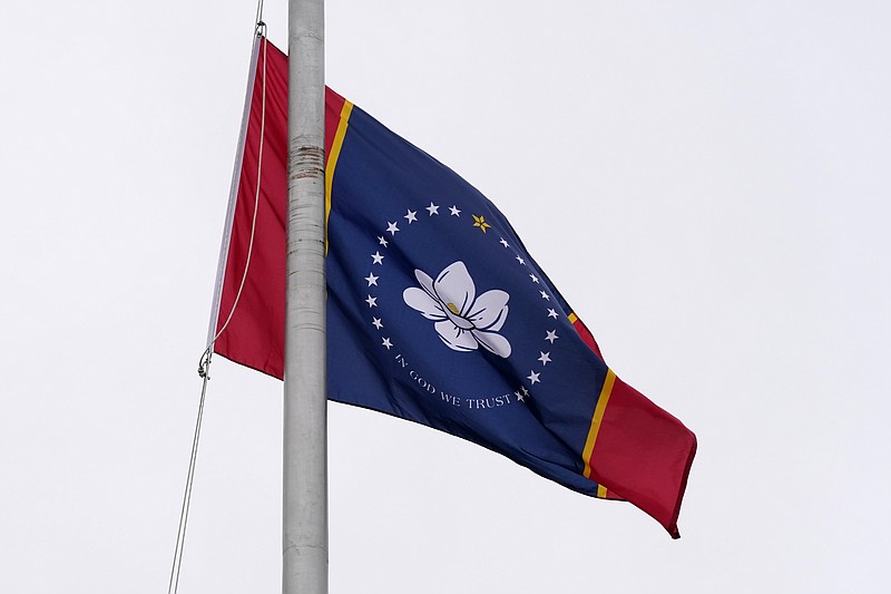 One of five final designs for the new Mississippi state flag flutters in the breeze, outside the Old Capitol Museum in Jackson, Miss., Aug. 25, 2020, in Jackson, Miss. (AP Photo/Rogelio V. Solis)