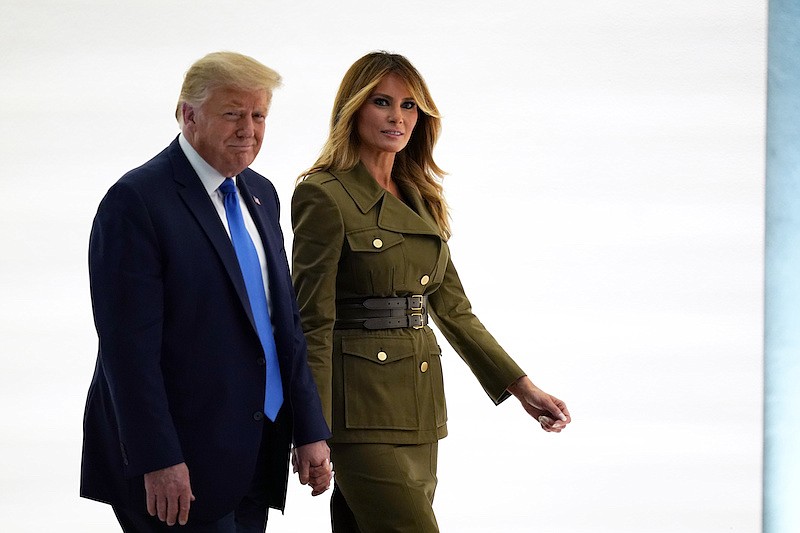 President Donald Trump leaves with first lady Melania Trump after her speech to the 2020 Republican National Convention from the Rose Garden of the White House, Tuesday, Aug. 25, 2020, in Washington. (AP Photo/Evan Vucci)