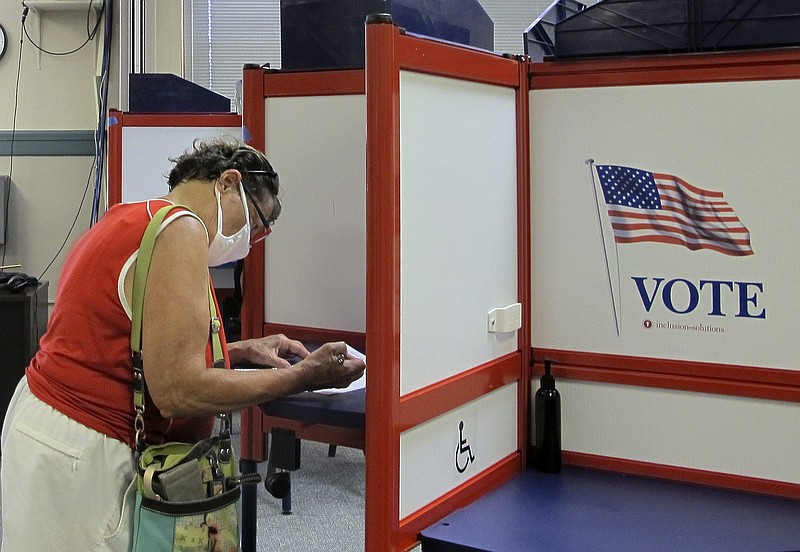 A voter marks her ballot in Vermont's statewide primary on Tuesday, Aug. 11, 2020, in Montpelier, Vt. (AP Photo/Lisa Rathke)