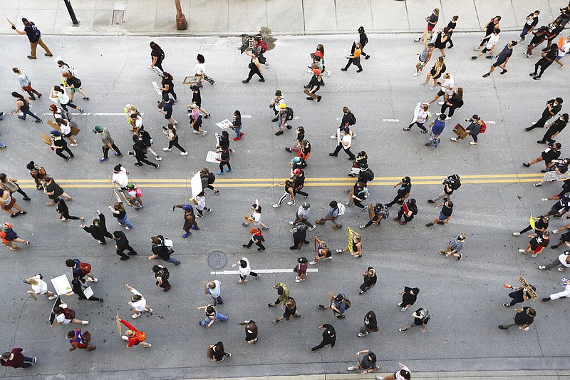 Demonstrators take part in a protest march Thursday, June 4, 2020, in Nashville, Tenn., over the death of George Floyd, who died May 25 after being restrained by police in Minneapolis. (AP Photo/Mark Humphrey)