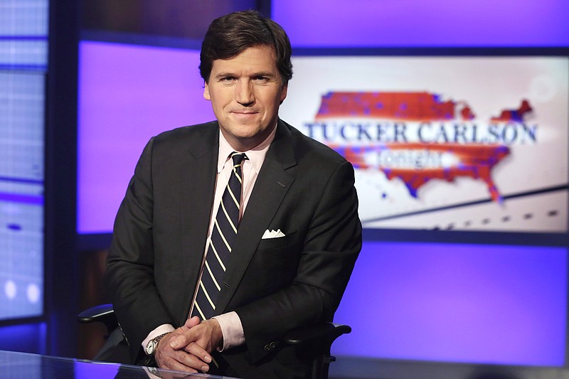 In this March 2, 2017, file photo Tucker Carlson, host of "Tucker Carlson Tonight," poses for photos in a Fox News Channel studio, in New York. Carlson is being criticized for suggesting that no one should be surprised by the killing of two demonstrators during social unrest in Kenosha, Wis. Authorities "stood back and watched Kenosha burn," he said on Fox News Channel on Wednesday, Aug. 27, 2020. "So are we really surprised that looting and arson accelerated to murder? How shocked are we that 17-year-olds with rifles decided they had to maintain order when no one else would?" (AP Photo/Richard Drew, File)