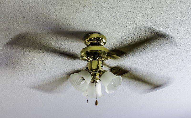 electric ceiling fan in motion, spinning around, colour image fan tile / Getty Images
 