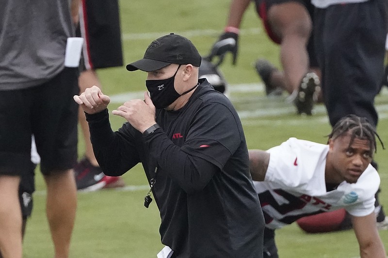 AP photo by John Bazemore / Atlanta Falcons coach Dan Quinn shadow boxes as his team stretches during training camp on Sunday.