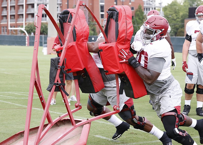 Alabama photo by Robert Sutton / Alabama senior left tackle Alex Leatherwood goes through a blocking drill during a recent practice in Tuscaloosa.