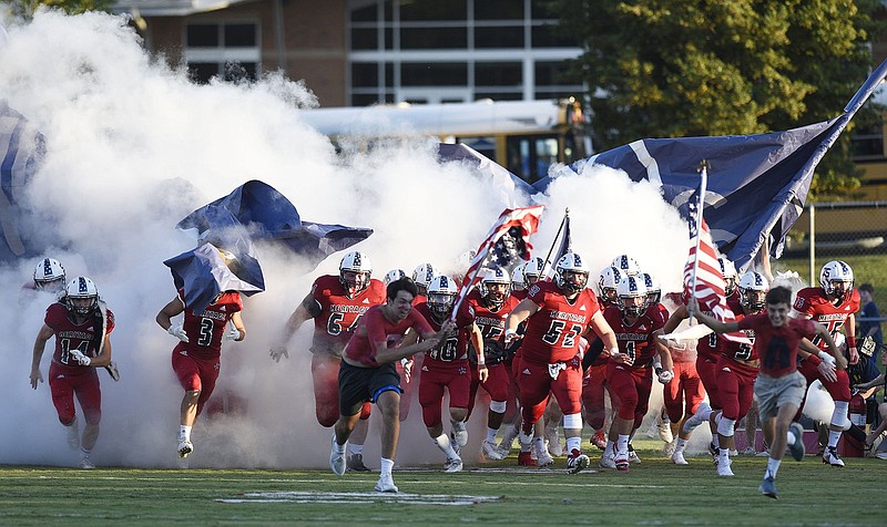 Staff photo by Robin Rudd / Heritage High School football players run onto the field before their home game against Catoosa County rival Ringgold on Aug. 30, 2019. Heritage remains in Region 7-AAAA this season, along with fellow local programs Northwest Whitfield and Ridgeland, but GHSA reclassification has added some new programs to the league.