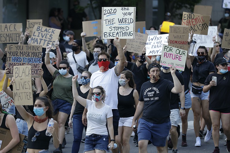 AP file photo, Mark Humphrey / Demonstrators took part in a peaceful protest march in Nashville in June over police brutality.