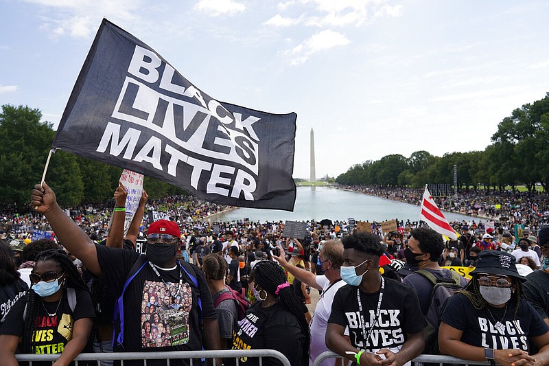 People attend the March on Washington, Friday Aug. 28, 2020, in Washington, on the 57th anniversary of the Rev. Martin Luther King Jr.'s "I Have A Dream" speech. (AP Photo/Carolyn Kaster)