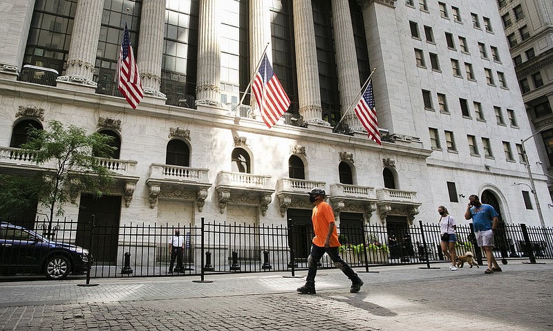 FILE - In this July 21, 2020 file photo, people walk by the New York Stock Exchange. Stocks keep ticking higher on Wall Street, and more gains for the S&P 500 Friday morning, Aug. 28 have it on pace to close out its fifth straight winning week. (AP Photo/Mark Lennihan, File)