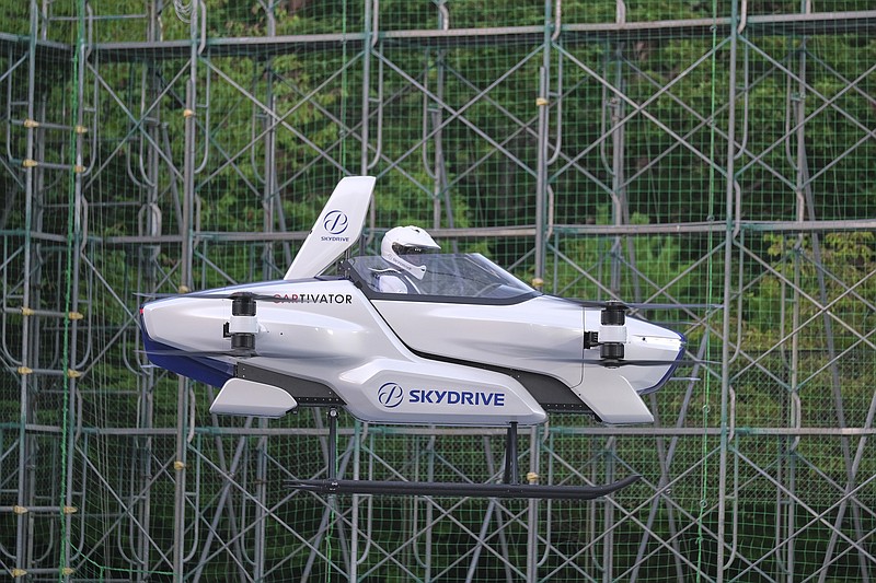 This photo taken at the beginning of August, 2020 and released by ©SkyDrive/CARTIVATOR 2020, shows a test flight of a manned '"flying car" at Toyota Test Field in Toyota, central Japan. Japan's SkyDrive Inc., among the myriads of "flying car" projects around the world, has carried out a successful though modest test flight with one person aboard. (©SkyDrive/CARTIVATOR 2020 via AP)