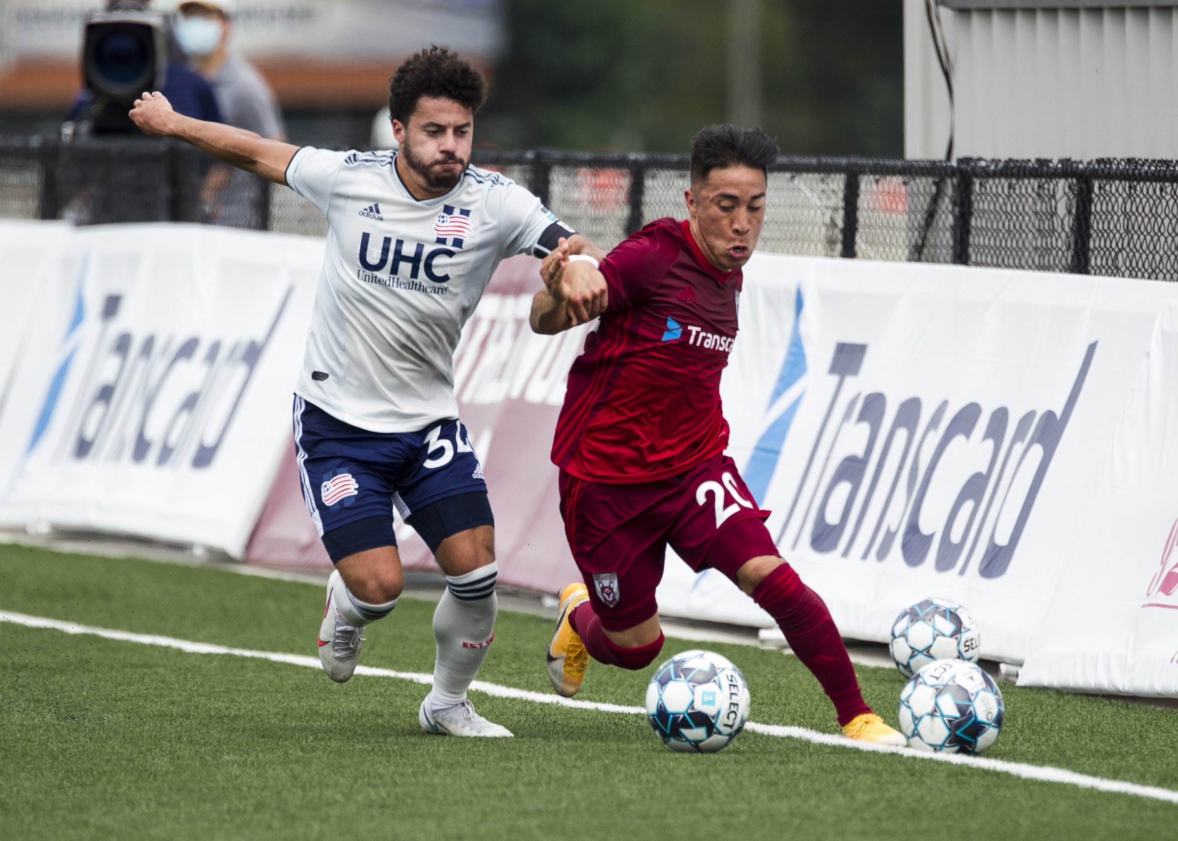 Staff photo by Troy Stolt / Chattanooga forward Marky Hernandez, right, competes for the ball with the New England Revolution II's Ryan Spaulding during the Red Wolves' 4-0 victory on Saturday at CHI Memorial Stadium in East Ridge.