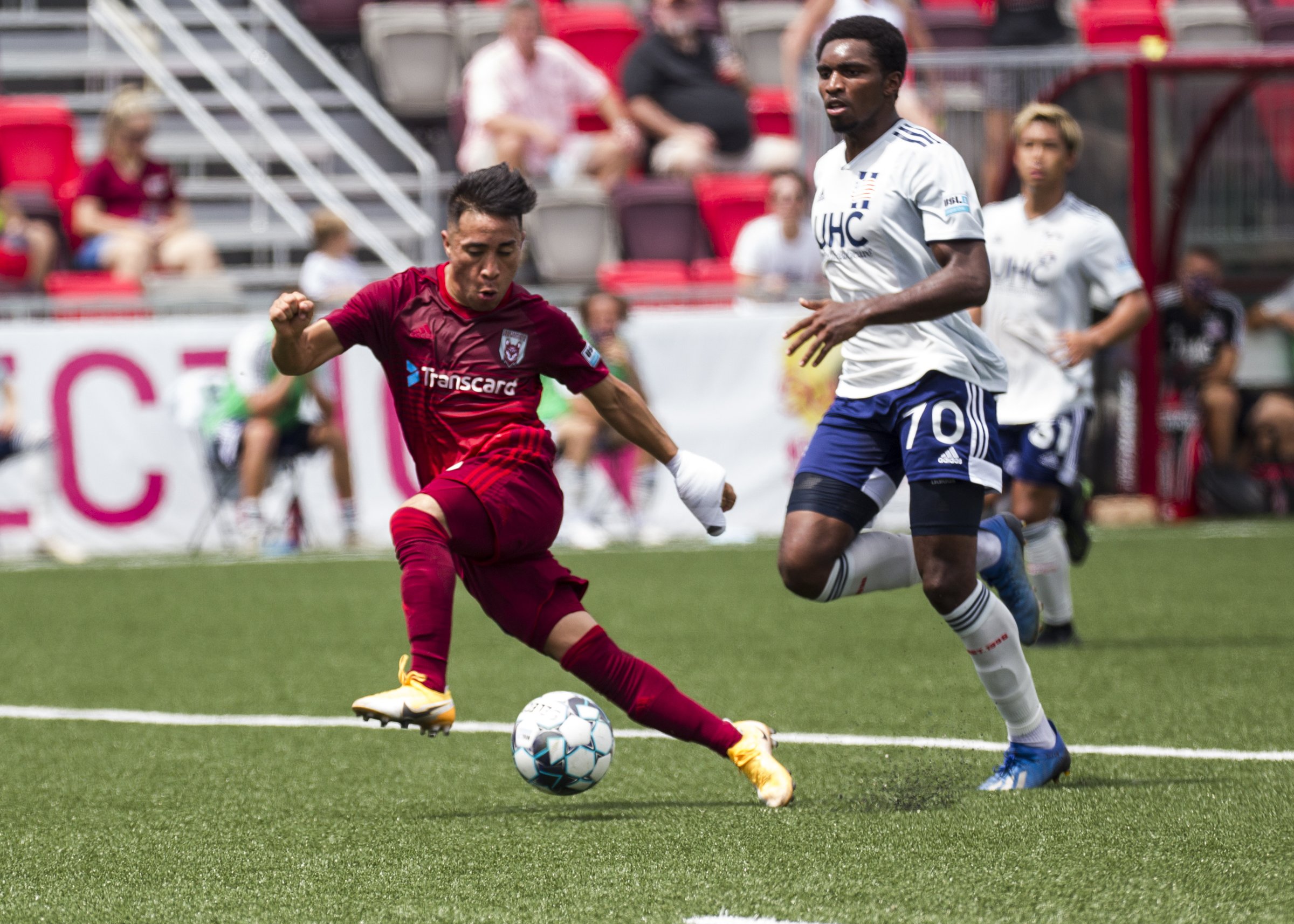 Staff photo by Troy Stolt / Chattanooga forward Marky Hernandez, left, gets past the New England Revolution II's Cristian Penilla on his way to a goal during the Red Wolves' 4-0 victory on Saturday at CHI Memorial Stadium in East Ridge.