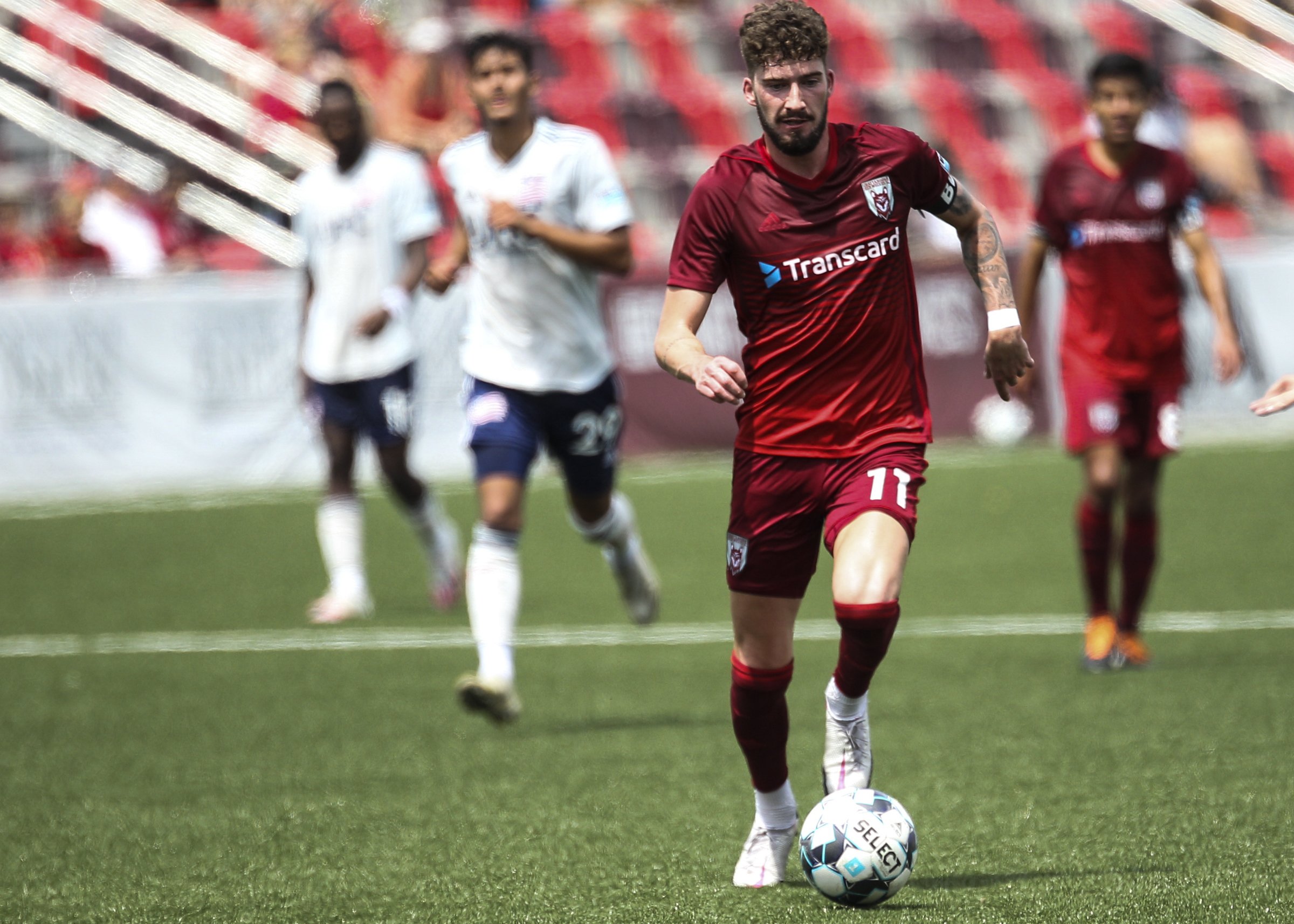 Staff photo by Troy Stolt / Chattanooga forward Greg Hurst dribbles the ball on a breakaway during the Red Wolves' 4-0 victory against the New England Revolution II on Saturday at CHI Memorial Stadium in East Ridge.