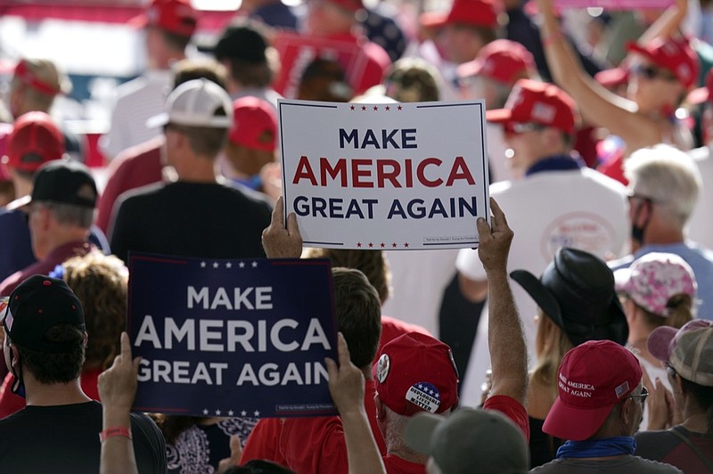 FILE - In this Aug. 28, 2020, file photo people hold up campaign signs as they wait for a rally for President Donald Trump to begin at Manchester-Boston Regional Airport in Londonderry, N.H. (AP Photo/Charles Krupa, File)


