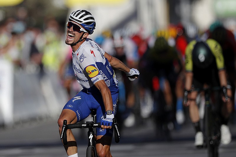 AP photo by Stephane Mahe / Julian Alaphilippe celebrates as he crosses the finish line to win the second stage of the Tour de France on Sunday in Nice, putting the 28-year-old French cyclist in the overall leader's yellow jersey. Marc Hirschi finished second and Adam Yates was third.