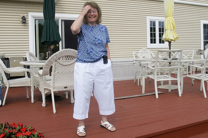 In this Aug. 24, 2020, photo Jean Grady smiles as she poses at her home in Westford, Vt. Grady wears an insulin pump to help manage her diabetes. Before the pandemic, Medicare rules required her make regular two-hour, one-way trips to New Hampshire to meet with her doctor to discuss her treatment. Medicare rule changes during the pandemic now makes it possible for her to meet with her doctor remotely, saving her from hours on the road. (AP Photo/Wilson Ring)