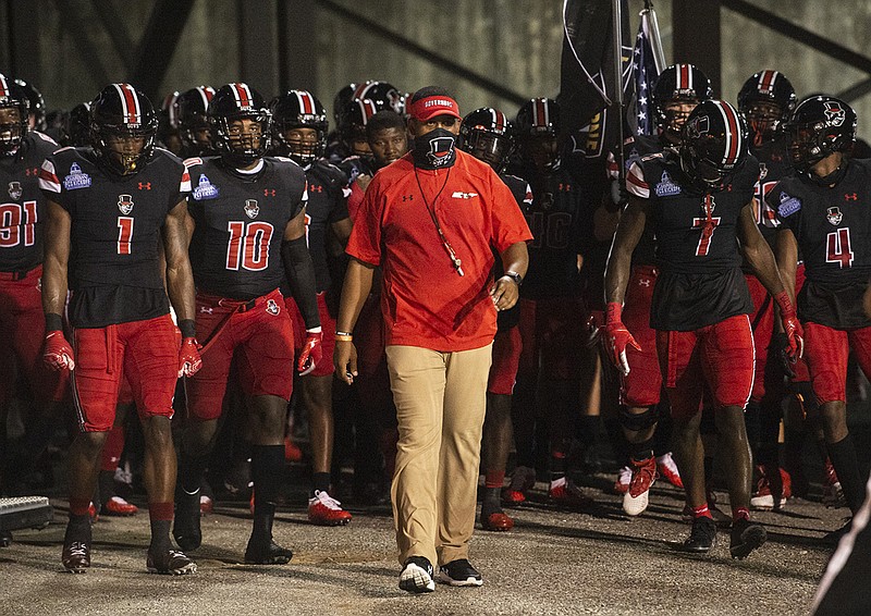 AP photo by Jake Crandall / Austin Peay football interim coach Marquase Lovings leads his team onto the field at the Cramton Bowl for a game against Central Arkansas on Saturday night in Montgomery, Ala.