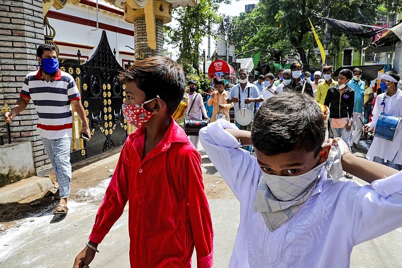 Muslims wearing face masks beat drums as they take part in a Muharram procession in Kolkata, India, Sunday, Aug. 30, 2020. India has the third-highest coronavirus caseload after the United States and Brazil, and the fourth-highest death toll in the world. (AP Photo/Bikas Das)