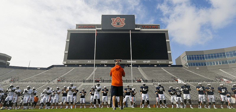 Auburn Athletics photo by Todd Van Emst / Auburn football players warm up before their first preseason scrimmage on Aug. 22. The Tigers have not practiced since last Tuesday due to coronavirus concerns and have at least 16 players who are out this week.