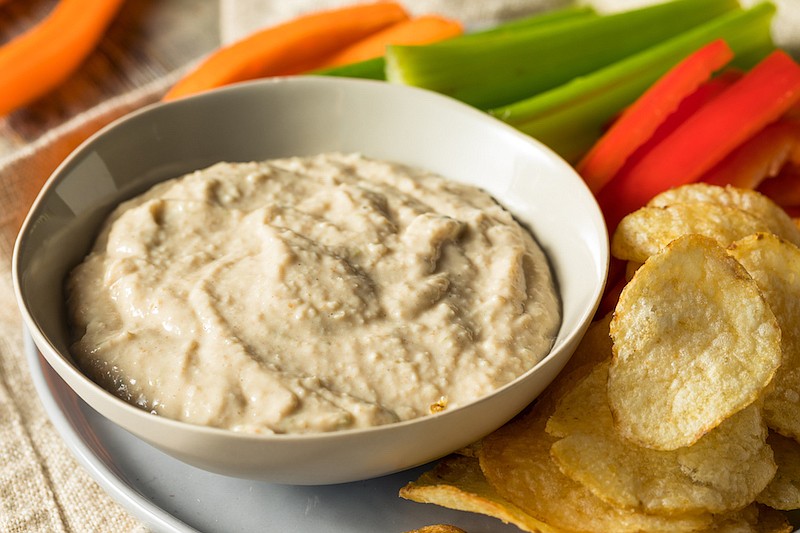 Homemade Carmelized Onion Dip with chips and veggies. / Photo credit: Getty Images/iStock/bhofack2