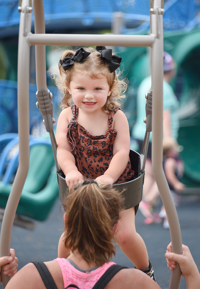 Staff photo by Matt Hamilton / Ringgold residents Alli Henry and her daughter Braylee, 2, swing together in Fort Oglethorpe's Gilbert-Stephenson Park, where the city recently opened its first inclusive playground.