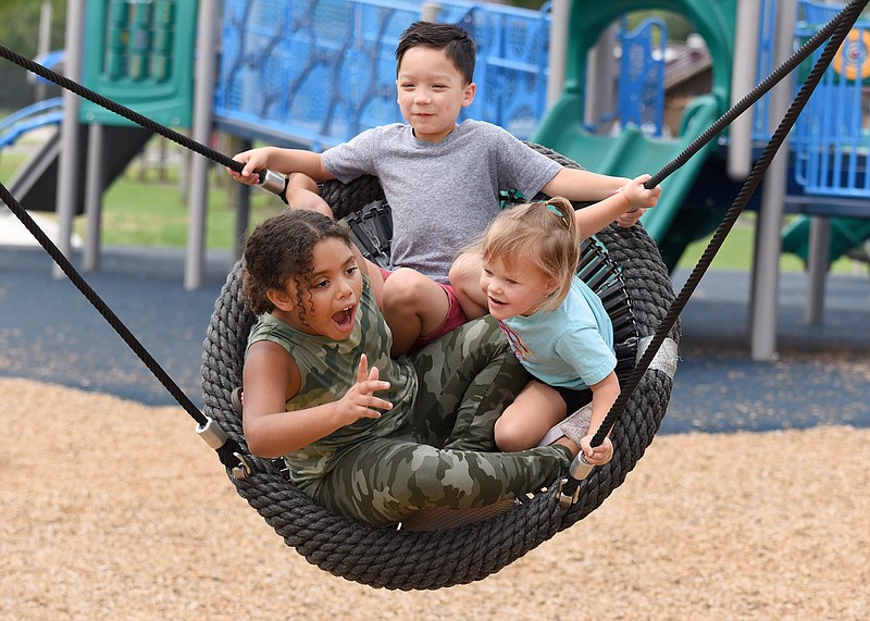 Staff photo by Matt Hamilton / From left, Aaliyah Jah, 7, Emory Wagner, 6, and Lennon Burton, 4, swing together at Gilbert-Stephenson Park in Fort Oglethorpe.