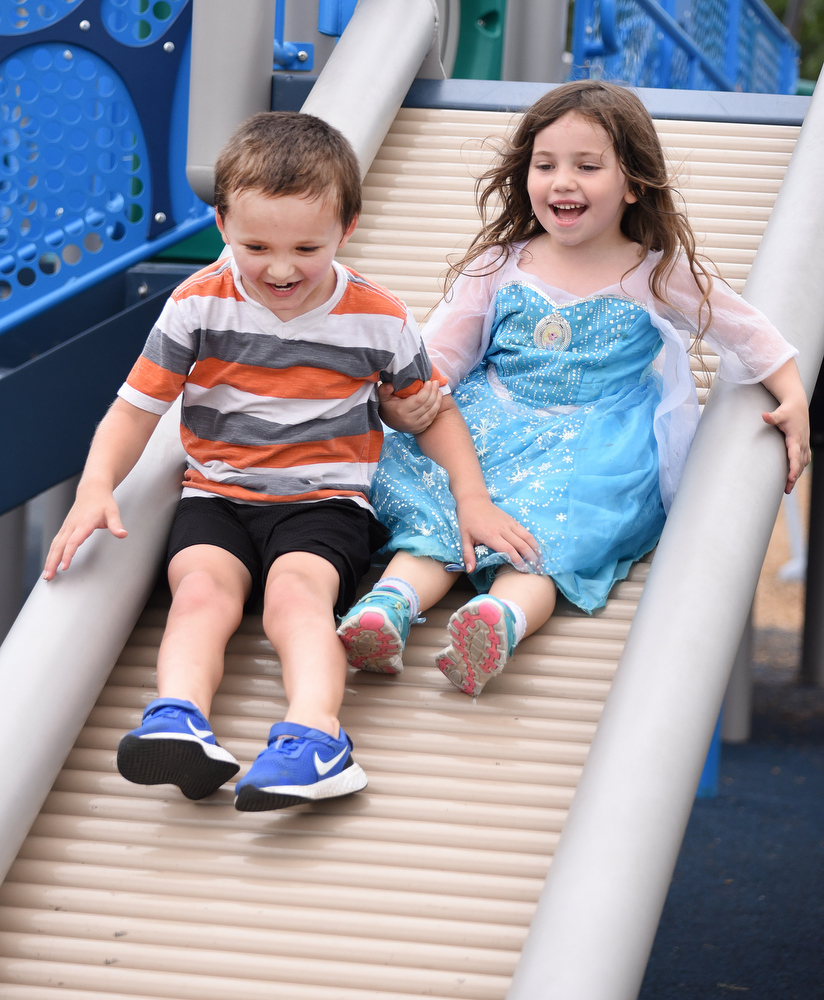 Staff photo by Matt Hamilton / Peyton DeMarr, 5, and Lucy Weber, 4, slide down a slide together at the recently opened playground at Gilbert-Stephenson Park in Fort Oglethorpe.