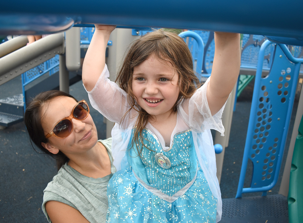 Staff photo by Matt Hamilton / Tishina DeMarr helps Lucy Weber, 4, as she plays at Gilbert-Stephenson Park in Fort Oglethorpe.