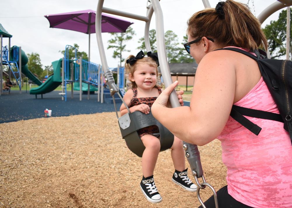 Staff photo by Matt Hamilton / Ringgold residents Alli Henry and her daughter Braylee, 2, swing together in Fort Oglethorpe's Gilbert-Stephenson Park, where the city recently opened its first inclusive playground.