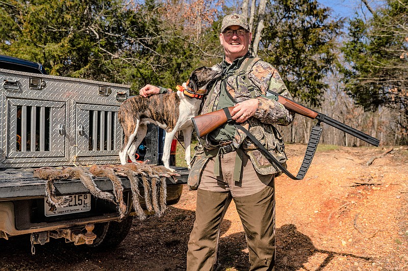 Photo by Larry Case / Outdoors columnist Larry Case poses with Dotzie, his mountain cur dog who looks forward to the late fall and trips to the woods to hunt squirrels.