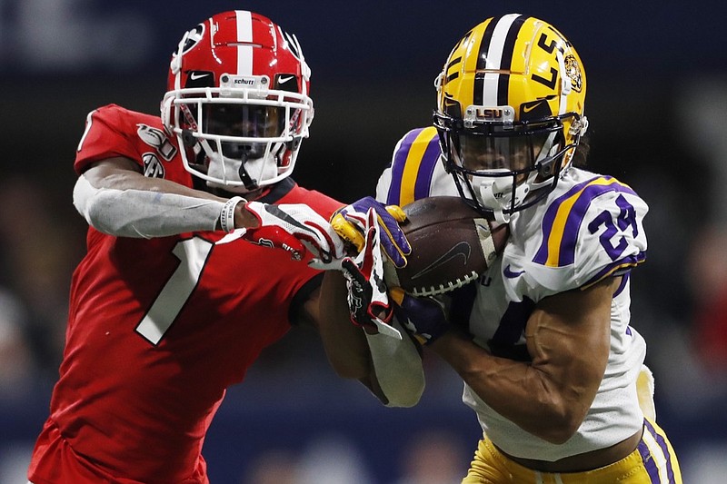 FILE - In this Dec. 7, 2019, file photo, LSU cornerback Derek Stingley Jr. (24) intercepts the ball from Georgia wide receiver George Pickens (1) during the second half of the Southeastern Conference championship NCAA college football game in Atlanta. Stingley Jr. was selected to The Associated Press preseason All-America first-team, Tuesday, Aug. 25, 2020. (AP Photo/John Bazemore, File)