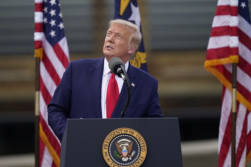 With the USS Battleship North Carolina in the background, President Donald Trump speaks on Wednesday, Sept. 2, 2020, in Wilmington, N.C. (AP Photo/Gerry Broome)