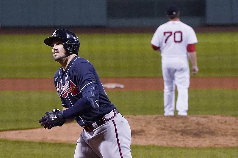 AP photo by Charles Krupa / Adam Duvall, left, heads to the Atlanta Braves' dugout in the eighth inning after touching the plate on his third home run of Wednesday night's 7-5 win against the host Boston Red Sox.