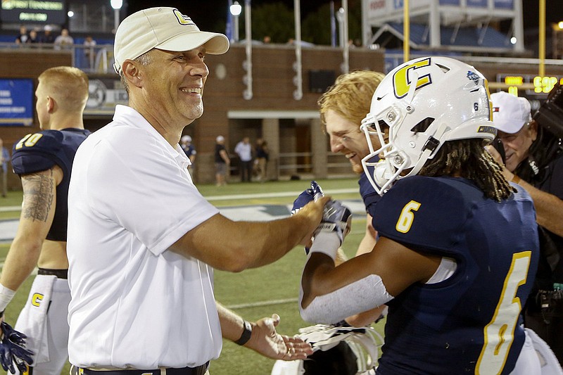 Staff photo by C.B. Schmelter / UTC football coach Rusty Wright smiles as he greets running back Jeffrey Wood II (6) after the Mocs' 24-10 victory over Eastern Illinois on Aug, 29, 2019, at Finley Stadium.