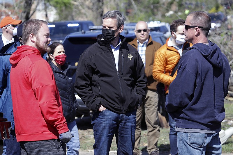 Tennessee Gov. Bill Lee, center, talks with residents as he visits a storm-damaged area in Chattanooga back in April after tornadoes struck. (AP Photo/Mark Humphrey)