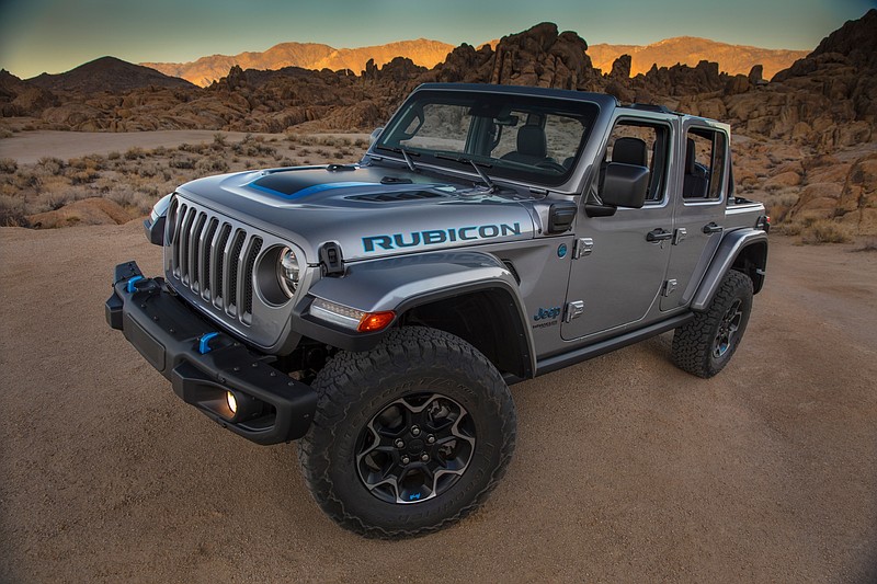 This photo provided by Fiat Chrysler shows the 2021 Jeep Wrangler Rubicon 4xe. Fiat Chrysler on Thursday, Sept. 3, 2020, unveiled the first of what it says will be many Jeeps powered by batteries. The Jeep Wrangler 4xe is the brand's first vehicle that can travel on electricity in the U.S. The gas-electric hybrid SUV can go 25 miles on battery power before a 2-liter, four-cylinder turbocharged engine takes over. (Fiat Chrysler via AP)