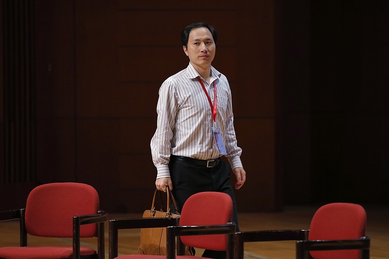 FILE - In this Wednesday, Nov. 28, 2018 file photo, genetic researcher He Jiankui arrives for the Human Genome Editing Conference in Hong Kong. A new report from an international commission of scientists sets criteria for when altering genes in human embryos might be considered, two years after He shocked the world by claiming to have made the first "CRISPR babies." (AP Photo/Kin Cheung)