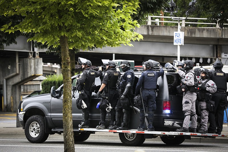 File photo Photo by Moriah Ratner of The Associated Press / Portland Police prepare to head towards Tom McCall Waterfront Park as right-wing groups and counterprotesters gathered in downtown Portland, Oregon, on Saturday, Aug. 17, 2019. Flag-waving members of the Proud Boys and Three Percenters militia group began gathering late in the morning, some wearing body armor and helmets. Meanwhile black clad, helmet and mask-wearing anti-fascist protesters — known as antifa — were also among the several hundred people on the streets.