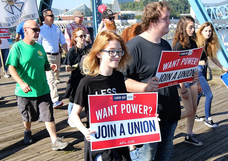 Staff File Photo By Erin O. Smith / Makayla Waldrup and Benjamin Scott, who had friends and family with the IATSE Local 140 labor union, march in the Chattanooga Labor Day Parade and Picnic in 2019.