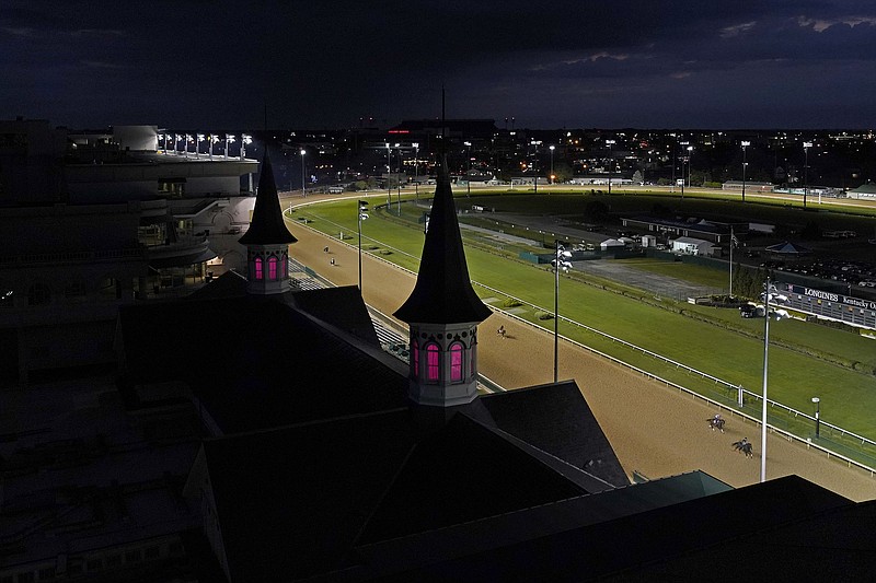 AP photo by Charlie Riedel / Horses run on the track early Friday morning at Churchill Downs in Louisville, Ky. The Kentucky Derby is Saturday evening, but it will be held without fans and the usual festive atmosphere, with the venue mostly empty as a result of the COVID-19 pandemic.