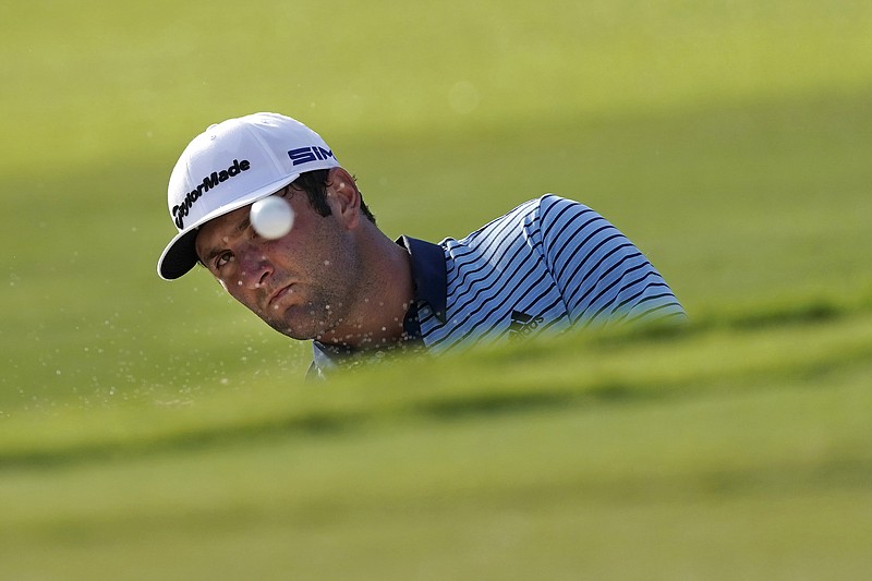 AP photo by John Bazemore / Jon Rahm hits from a greenside bunker on the 18th hole during the first round of the Tour Championship on Friday at East Lake Golf Club in Atlanta. Rahm shot a 65 to catch Dustin Johnson as they shared the lead at 13 under. Johnson, the No. 1 seed in the PGA Tour's FedEx Cup playoffs finale, started the round at 10 under and two strokes ahead of Rahm.