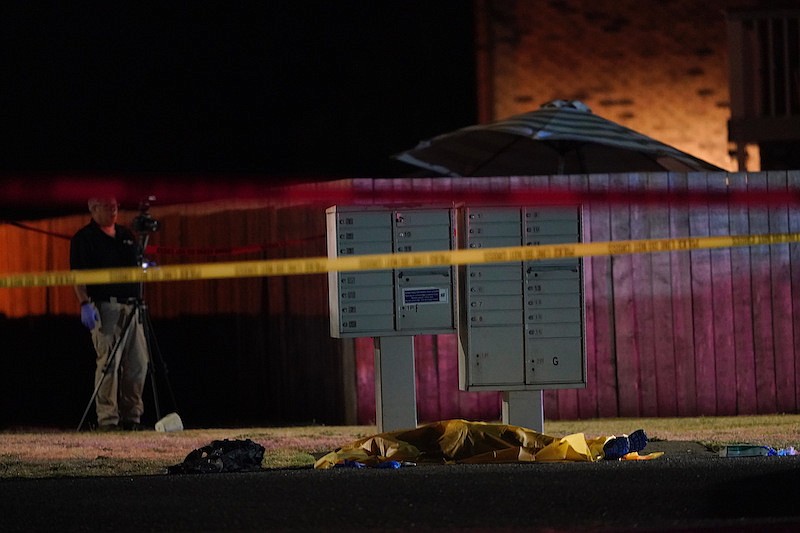 Officials work at a scene, late Thursday, Sept. 3, 2020, where a man suspected of fatally shooting a supporter of a right-wing group in Portland, Ore., the week before, was killed as investigators moved in to arrest him in Lacey, Wash. (AP Photo/Ted Warren)