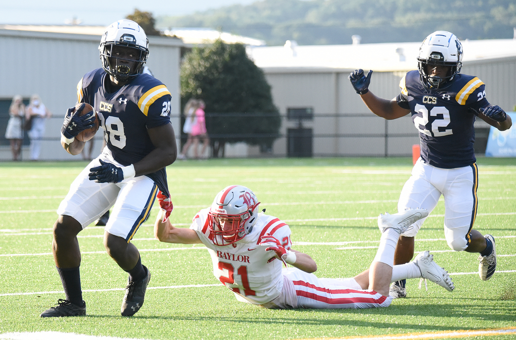 Staff photo by Matt Hamilton / Chattanooga Christian School's Traveon Scott breaks a tackle attempt by Baylor's Porter Kaufman during Friday night's game at CCS.