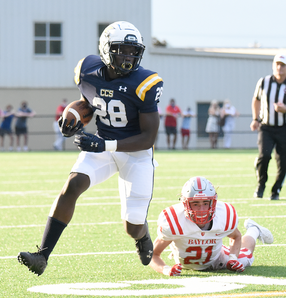 Staff Photo by Matt Hamilton / Chattanooga Christian School (28) Traveon Scott breaks a tackle by Baylor (21) Porter Kaufman Friday. The Chattanooga Christian School Chargers hosted the Baylor School Red Raiders Friday.