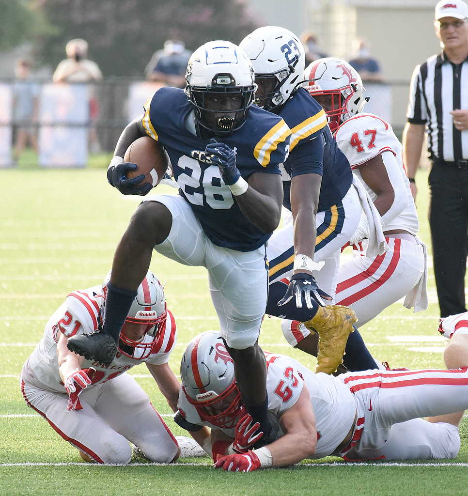 Staff Photo by Matt Hamilton / Chattanooga Christian School (28) Traveon Scott breaks a tackle by Baylor (21) Porter Kaufman and (53) Heath Snodgrass Friday.The Chattanooga Christian School Chargers hosted the Baylor School Red Raiders Friday.