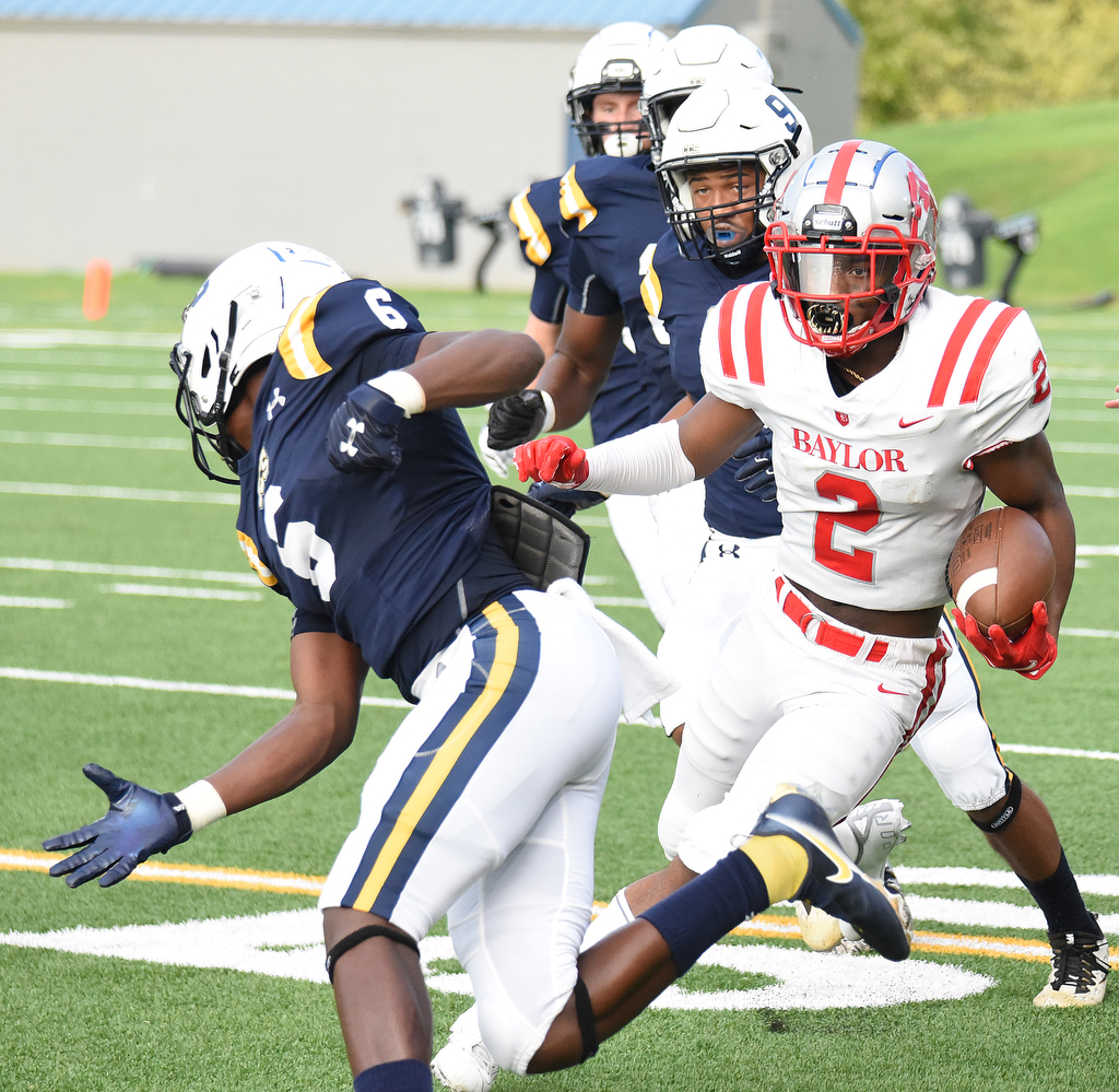 Staff Photo by Matt Hamilton / Baylor (2) Elijah Howard makes a move and Chattanooga Christian (6) Boo Carter tries to adjust to attempt a tackle. The Chattanooga Christian School Chargers hosted the Baylor School Red Raiders Friday.
