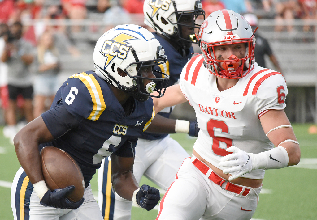 Staff Photo by Matt Hamilton / Chattanooga Christian (6) Boo Carter returns a kickoff as Baylor (6) Trey McDonald attempts the tackle. The Chattanooga Christian School Chargers hosted the Baylor School Red Raiders Friday.