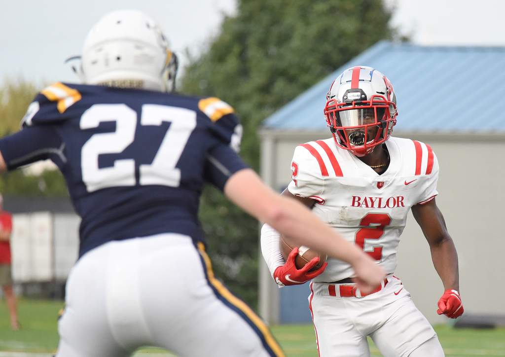 Staff Photo by Matt Hamilton / Baylor (2) Elijah Howard looks for daylight as Chattanooga Christian (27) Rafe Montgomery defends. The Chattanooga Christian School Chargers hosted the Baylor School Red Raiders Friday.