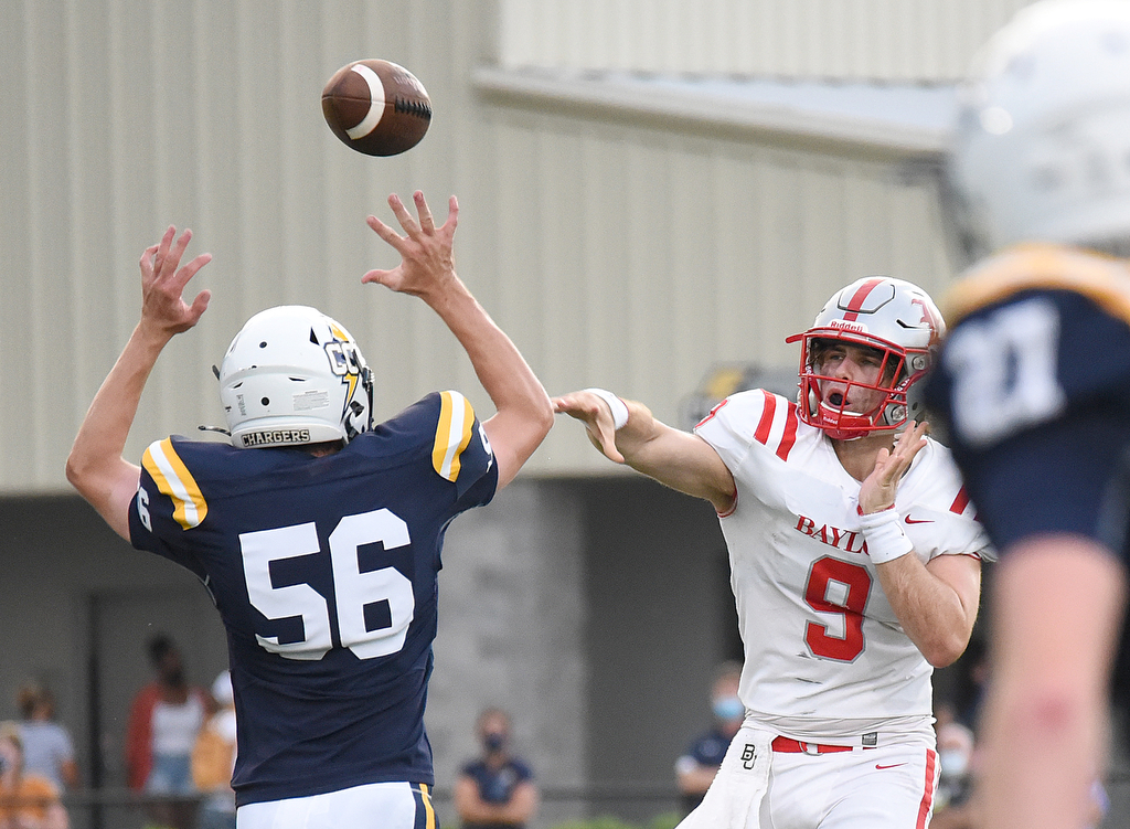 Staff Photo by Matt Hamilton / Chattanooga Christian (56) Noah Officer rushes Baylor (9) Neyland Jean as he throws the ball. The Chattanooga Christian School Chargers hosted the Baylor School Red Raiders Friday.