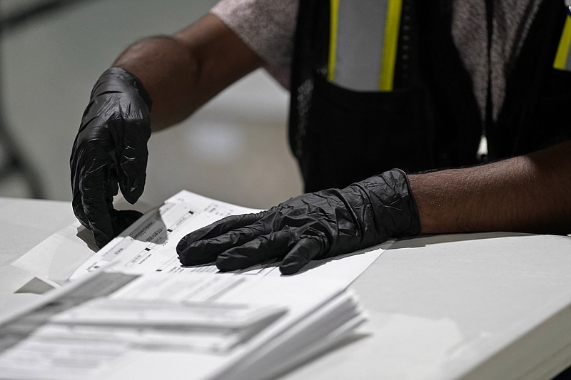 A workers prepares absentee ballots for mailing at the Wake County Board of Elections in Raleigh, N.C., Thursday, Sept. 3, 2020. North Carolina is scheduled to begin sending out more than 600,000 requested absentee ballots to voters on Friday. (AP Photo/Gerry Broome)